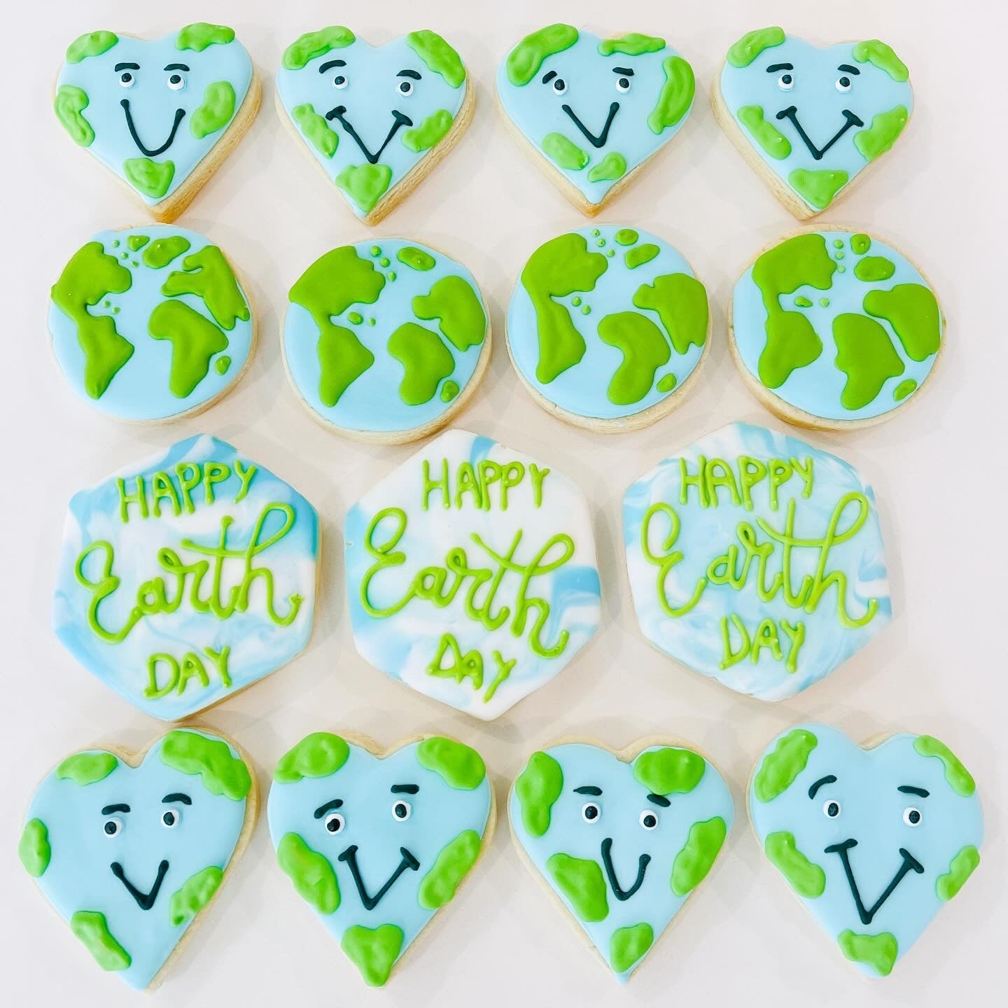 12 count Earth Day sugar cookies shaped like planet Earth and green leaves for eco-friendly party favors