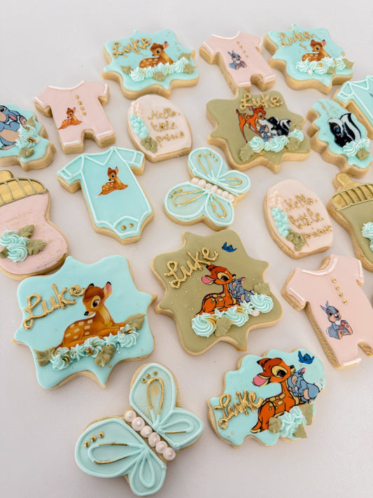 12 Bambi-themed baby shower sugar cookies with woodland-inspired designs, perfect for baby showers, party favors, and dessert tables.